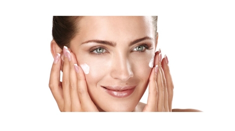 Beautiful Model Applying Cosmetic Cream Treatmen On Her Face
